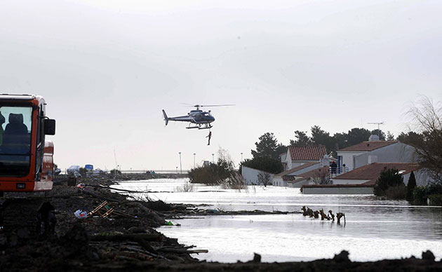 Storm damage in Europe: A helicopter evacuates inhabitants after flooding in L'Aguillon sur Mer
