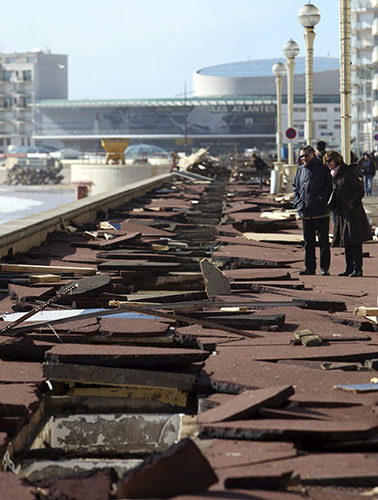 Storm damage in Europe: People look at the damage caused to the boardwalk at Les Sables d'Olonne