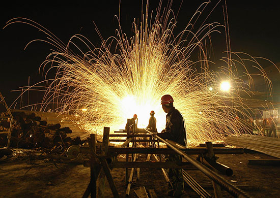 24 hours in pictures: Huaibei, China: Workers weld steel bars at a factory