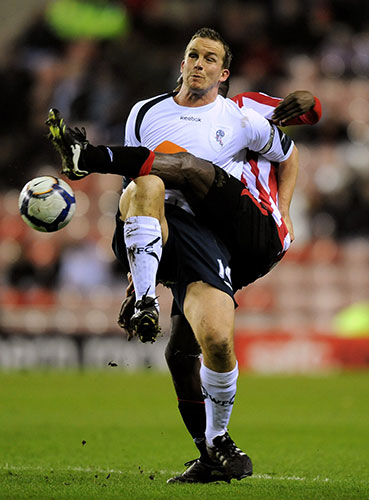 Tuesday: Bolton's Kevin Davies is challenged by Sunderland's John Mensah 