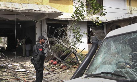 A policeman stands outside the World Vision aid agency office