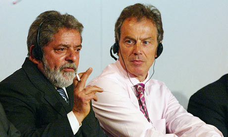 Brazilian President Luiz Inacio Lula Di Silva smokes at a symposium.