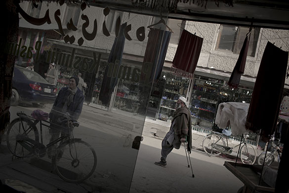 24 hours in pictures: Kabul, Afghanistan: An amputee walks in a commercial area