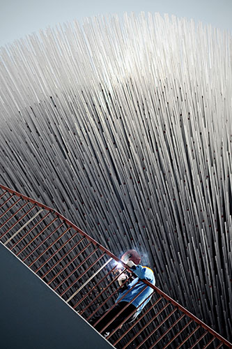 24 hours in pictures: Shanghai, China: A worker in front of the UK pavilion