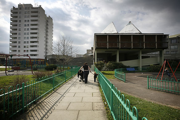 Week in business: A woman and child in a playground on the Thamesmead Estate