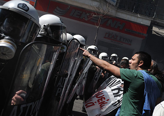 more strikes in greece: A protester confronts riot police during a demonstration in central Athens 