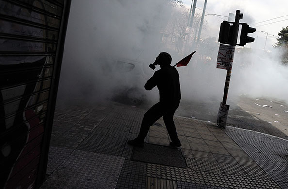 more strikes in greece: A demonstrator wearing a gas mask in Athens