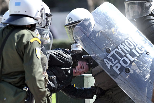 more strikes in greece: Riot police detain a demonstrator in Athens 