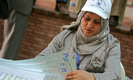 A Baghdad electoral worker counts ballots in Iraqi elections March 2010