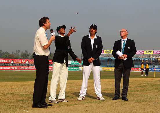 Bangladesh v England Day1: Bangladesh captain Al Hasan tosses the coin watched by England captain Cook