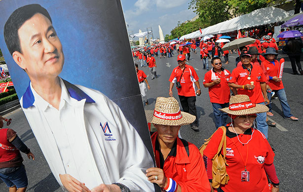 Thailand protests: Supporters of deposed Thai premier Thaksin Shinawatra carry his portrait