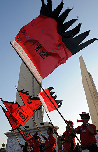 Thailand protests: Supporters of deposed Thai premier Thaksin Shinawatra wave red flags