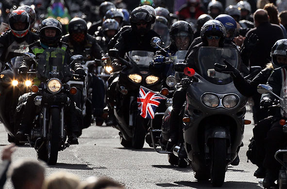 Wootton Bassett bikers: Some of the 10,000 bikers pass along the High Street