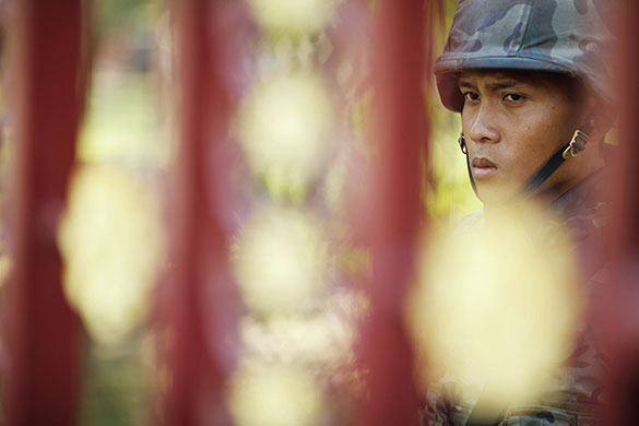 Thailand protests: A Thai soldier secures the gates after a grenade attack at a military base