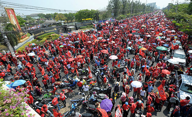 Thailand protests: 15 March: Red-shirted supporters wave flags 
