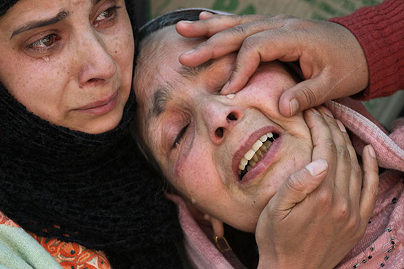 24 hours in pictures: Srinagar, India: A mother cries at a protest against the arrest of her son