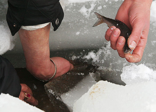 24 hours in pictures: Kiev, Ukraine: People break ice on a reservoir on the Dniper river to fish