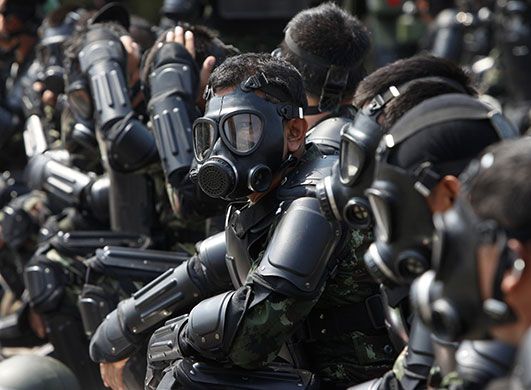 Thailand blood protest: Thai riot soldiers wearing gas masks take part in a practice