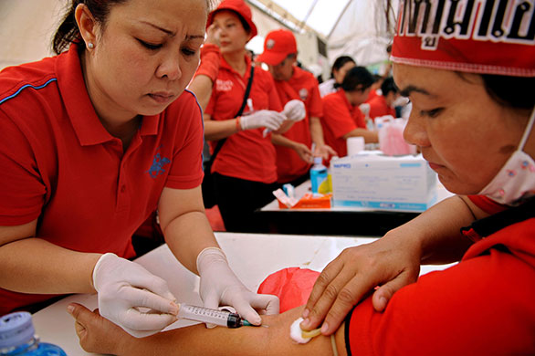 Thailand blood protest: A red-shirted supporter of deposed premier Thaksin Shinawatra donates blood