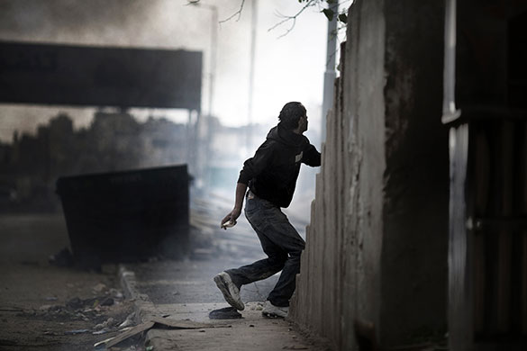 East Jerusalem protests: A Palestinian demonstrator holds a stone during clashes