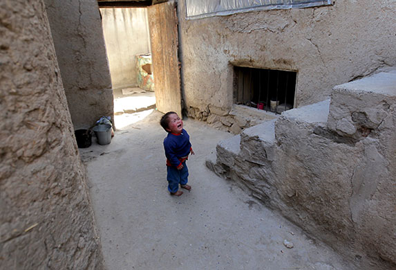 24 hours in pictures: Kabul, Aghanistan: A boy cries after receiving the polio vaccine 