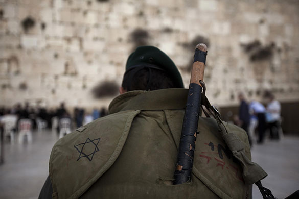 24 hours in pictures: Jerusalem: An Israeli border policeman prays at the Western Wall