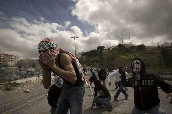 24 hours in pictures: Masked Palestinian youths throw stones at Israeli soldiers in Jerusalem