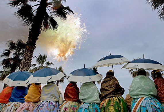Las Fallas in Valencia: Fallas in Valencia Several 'falleras' under their umbrellas