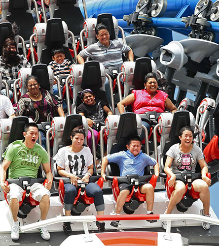 24 hours in pictures: Visitors ride the Battlestar Galactica roller coaster in Singapore