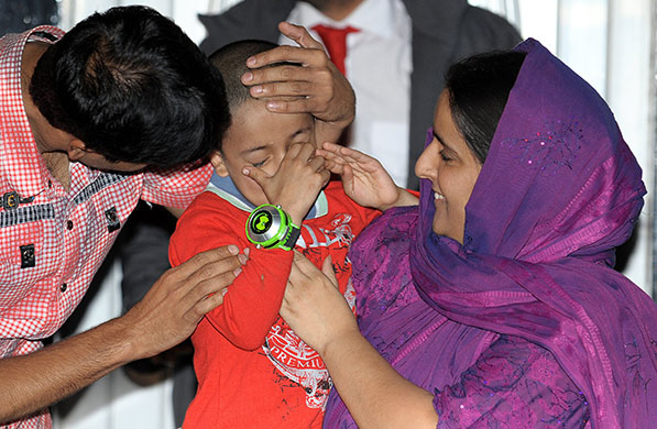 sahil saeed: Sahil Saeed with his mother and father at home in Oldham