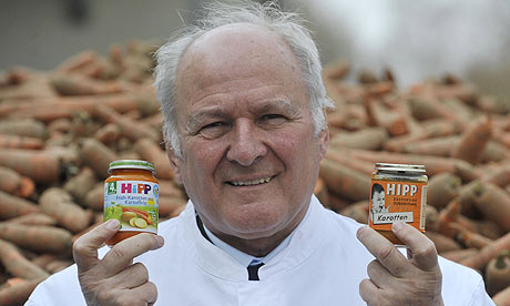 Claus Hipp with two jars of Hipp baby food at the company's German  HQ