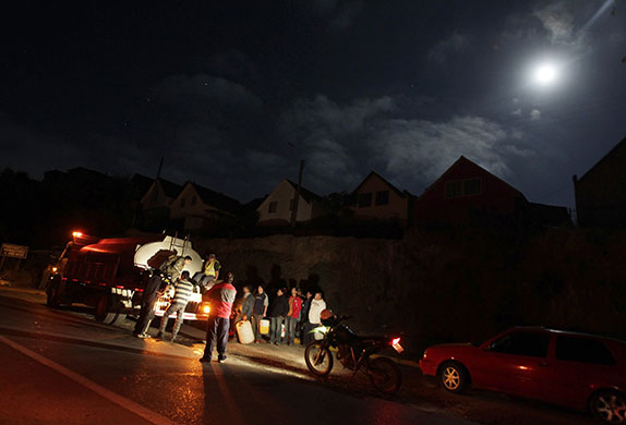 Chile after the quake: Residents receive potable water from a tanker truck  in Constitucion, Chile