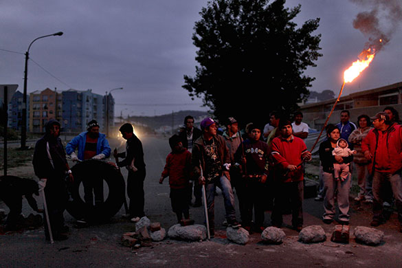 Chile after the quake: People stand outside their homes, guarding them from looters in Concepcion