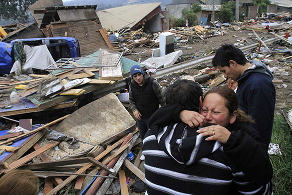 Chile after the quake: A family gathers outside their destroyed home in Constitucion