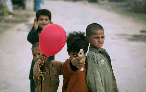24 hours in pictures: Rawalpindi, Pakistan: Afghan refugee boys play in the street