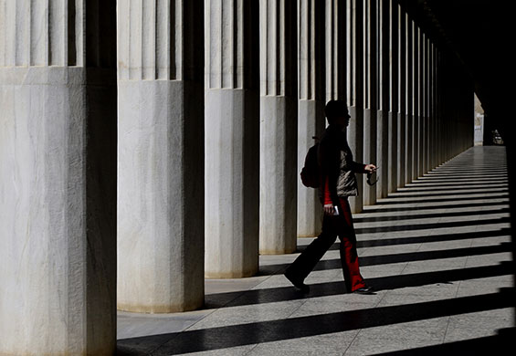 24 hours in pictures: Athens, Greece: A tourist walks through the Agora