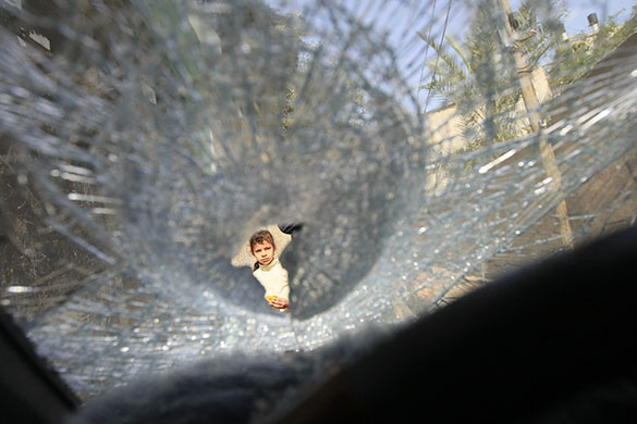 24 hours in pictures: A damaged car following an Israeli air strike 