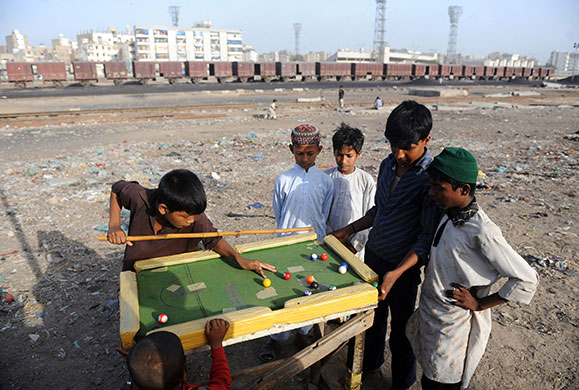 24 hours in pictures: Pakistani children play snooker