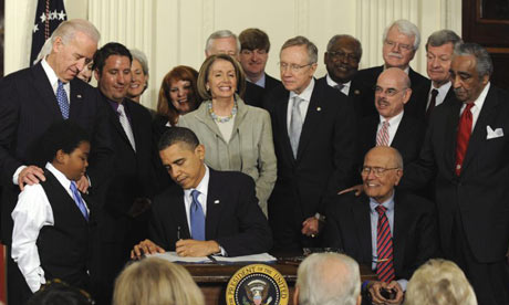 President Obama signing healthcare reform law