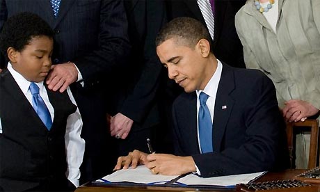 Barack Obama signs healthcare bill