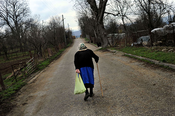 24 hours in pictures: Chernovrah, Bulgaria: An elderly after shoping at a travelling grocery