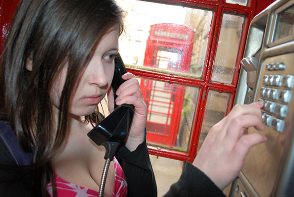 Unemployment : Unemployed young woman in phone box