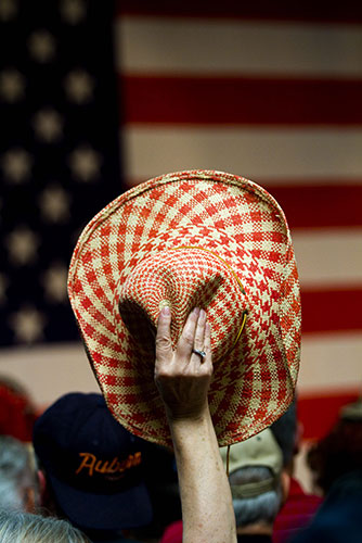 24 Hours in Pictures: A supporter holds up a cowboy hat at a campaign rally for John McCain 