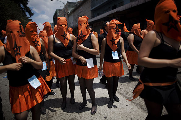 24 Hours in Pictures: Students wear orange hoods in the annual 