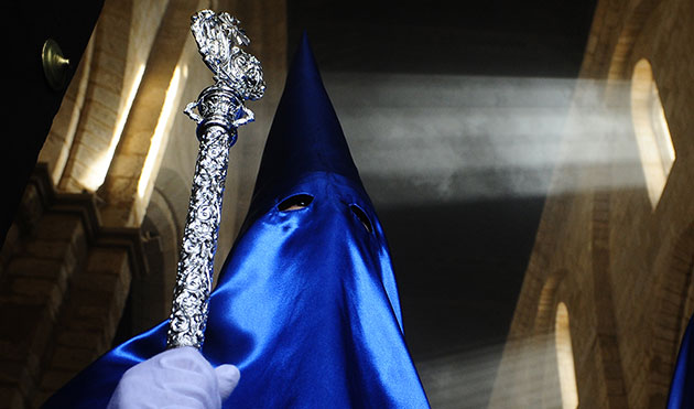 24 hours in pictures: A penitent takes part in a Holy Week procession in Cordoba, Spain,