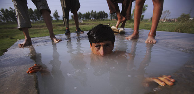 24 hours in pictures: A Pakistani youth swims in a water reservoir, Islamabad 