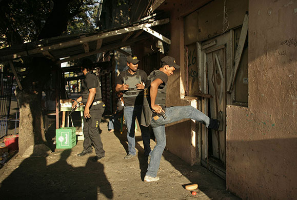 24 hours in pictures: Dominican Republic police enter a house in Santo Domingo