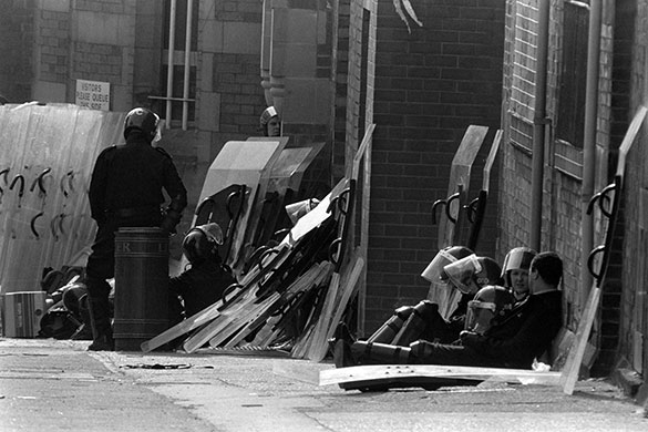 Strangeways riots: Exhausted riot police sit near piled up riot shields at Strangeways