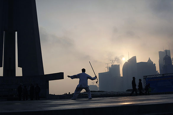 24 hours in pictures: Shanghgai, China: A man practices martial arts at the Bund