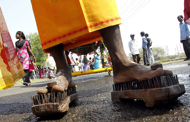 24 hours in pictures: A Hindu wears nails studded footwear during Karthikeya Puja